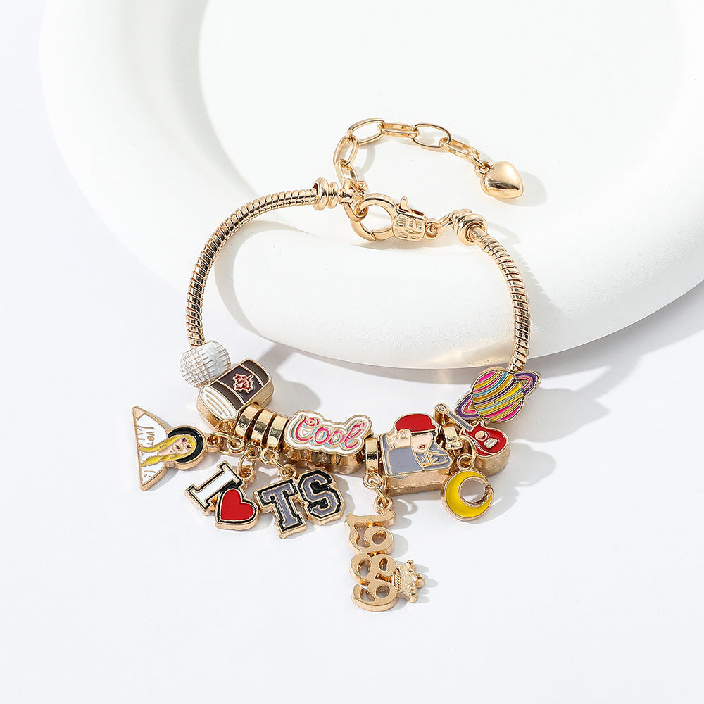 Finished gold-tone charm bracelet with enamel charms