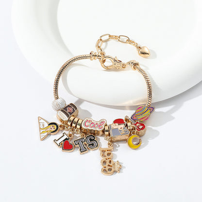 Finished gold-tone charm bracelet with enamel charms
